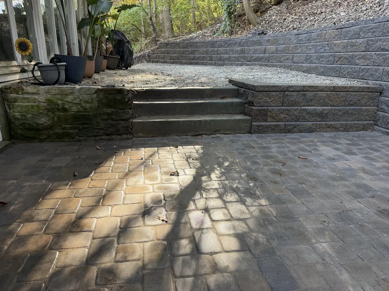 Block steps rising from the paver patio to the upper landing by the back door in Cincinnati, OH