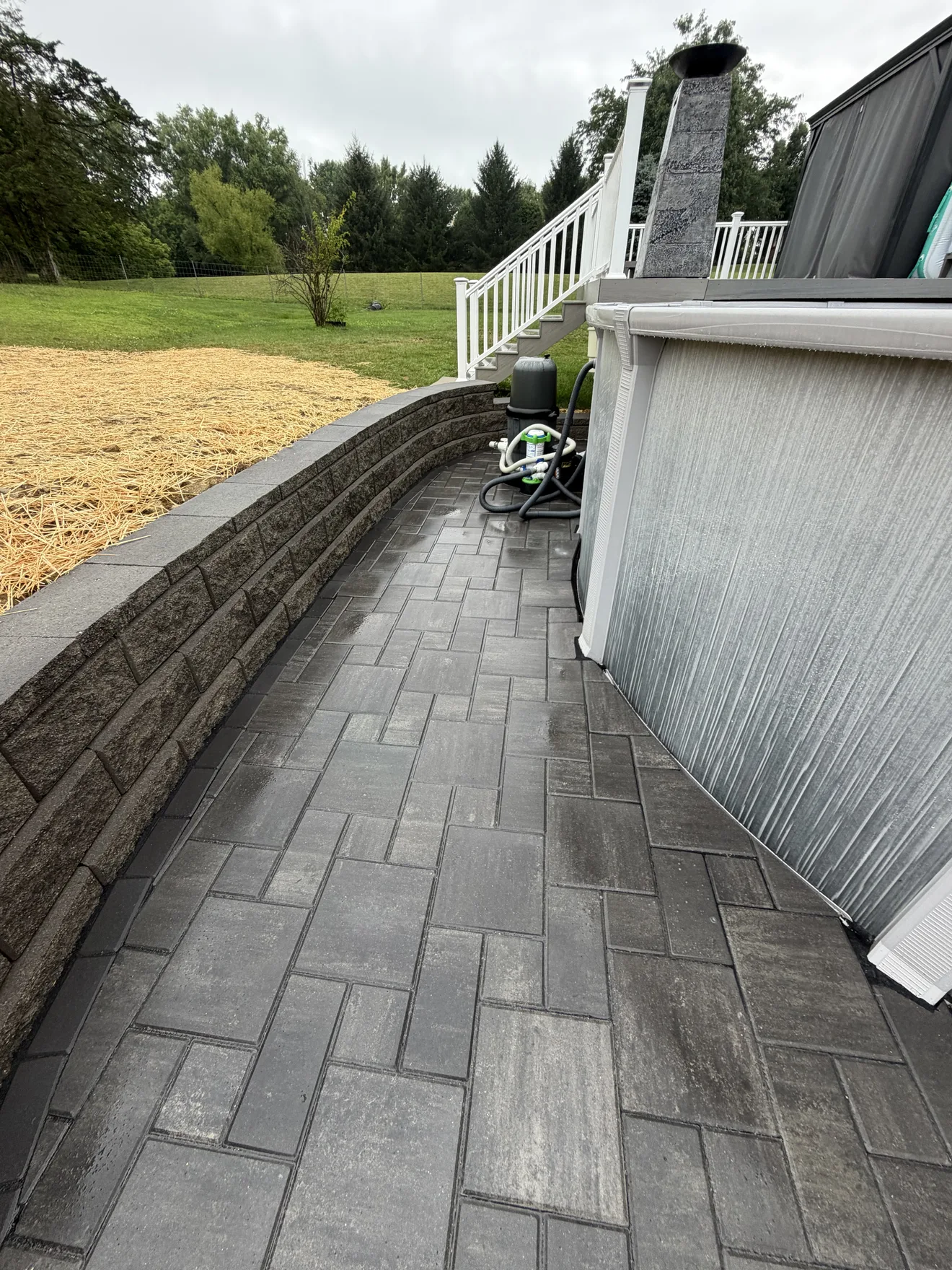 Paver walkway running between the pool and the new retaining wall in Lebanon, OH