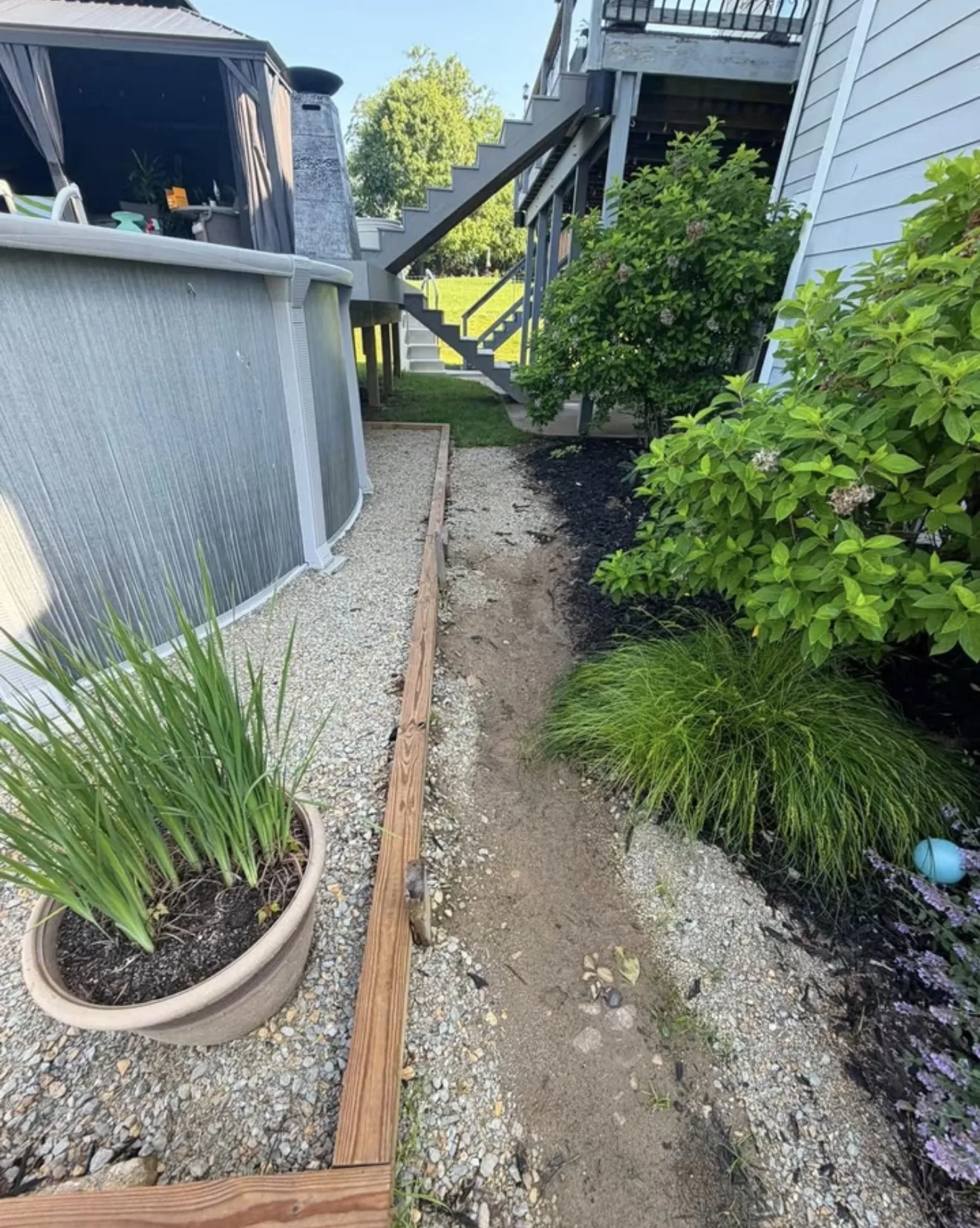 Washed out gravel path beside the pool in Lebanon, OH where runoff was cutting through the bed
