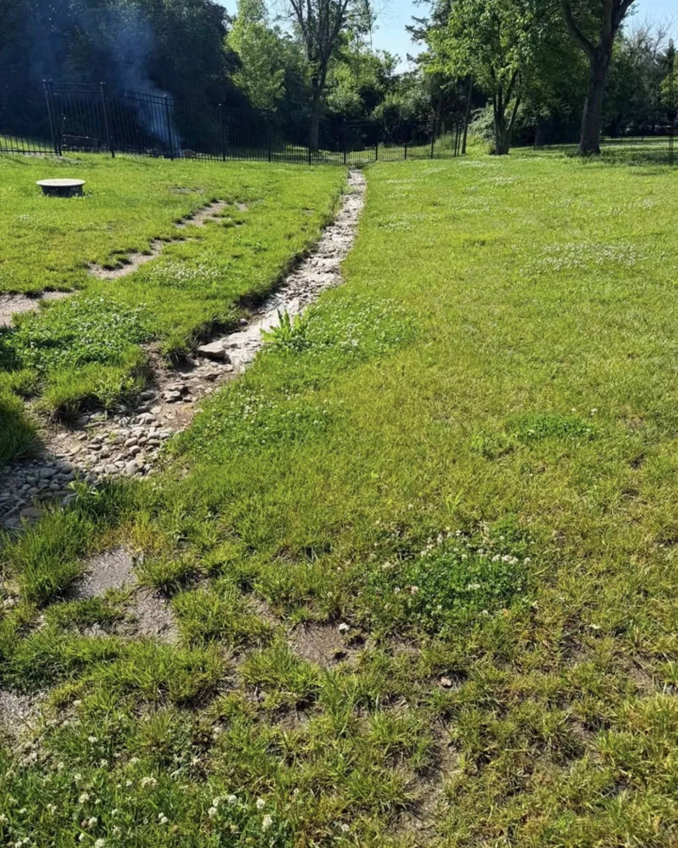 Standing water and eroded grade along the pool in Lebanon, OH before drainage work