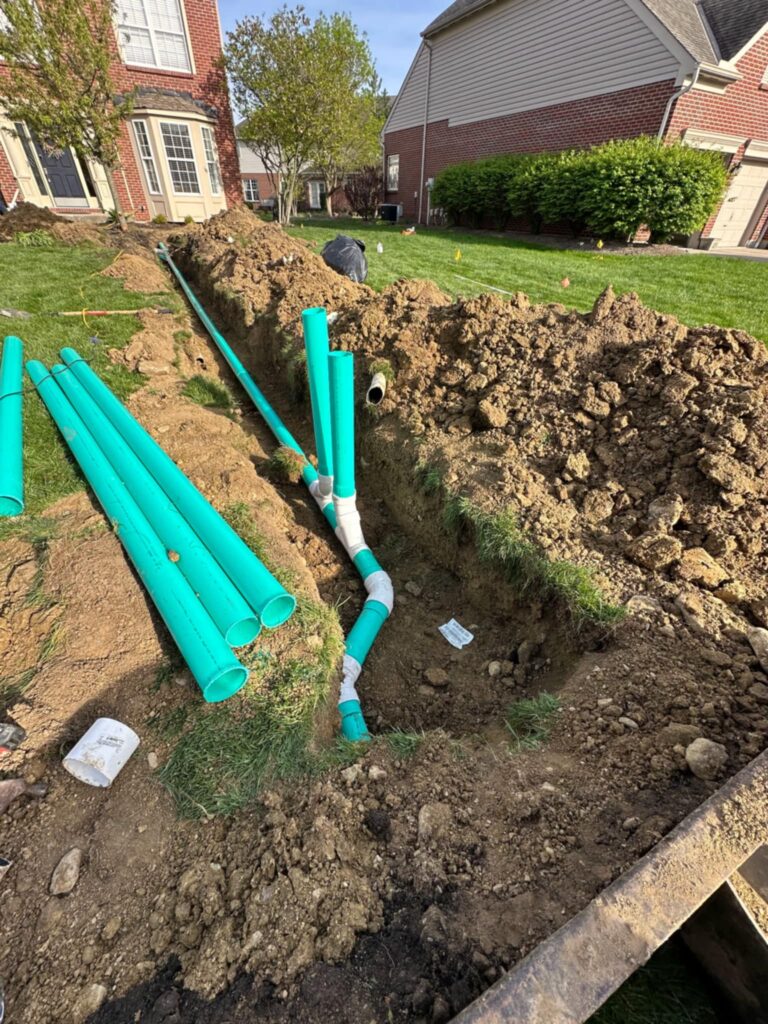 Drain system installation with cleanouts in progress by Shawn’s Landscape & Design in Mason, Ohio before final grading and completion.