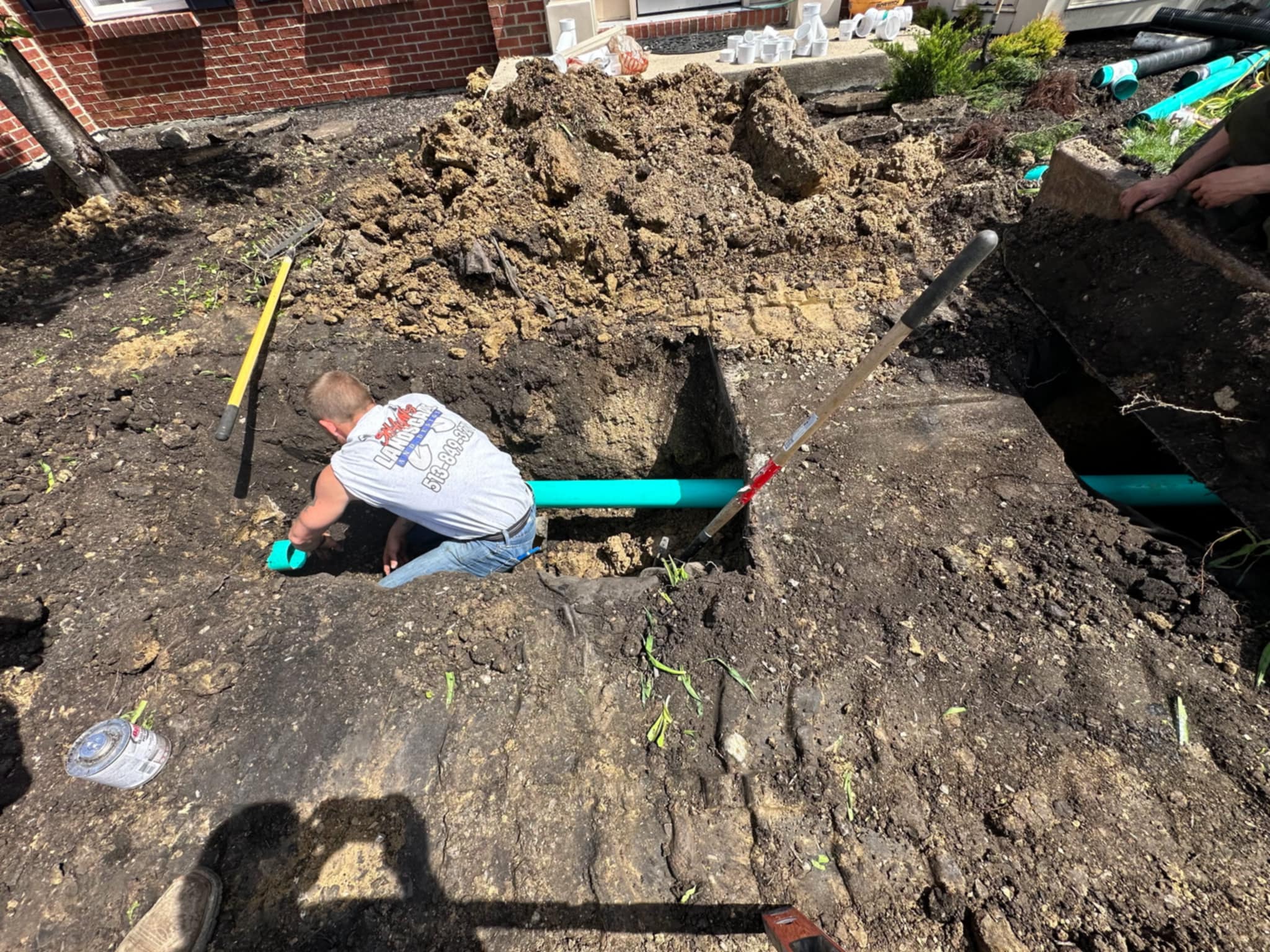 Custom drainage solution installed beneath a concrete sidewalk to correct water flow issues and protect surrounding areas from erosion.