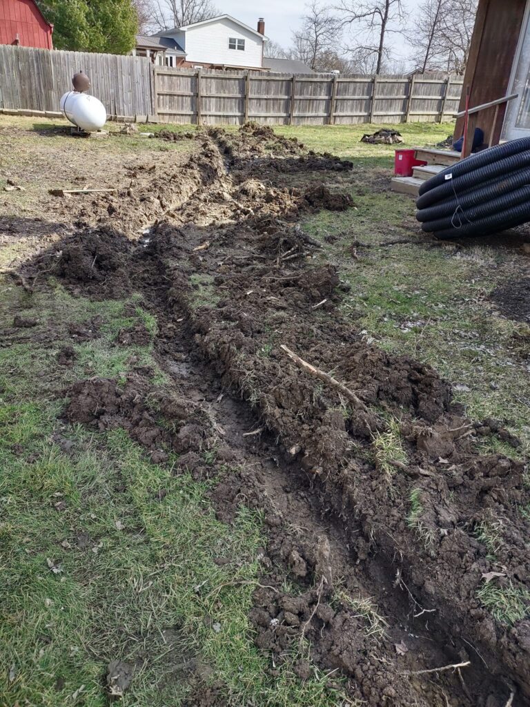 Drainage pipe and gravel base installation prep in Liberty Township, Ohio by Shawn’s Landscape & Design.